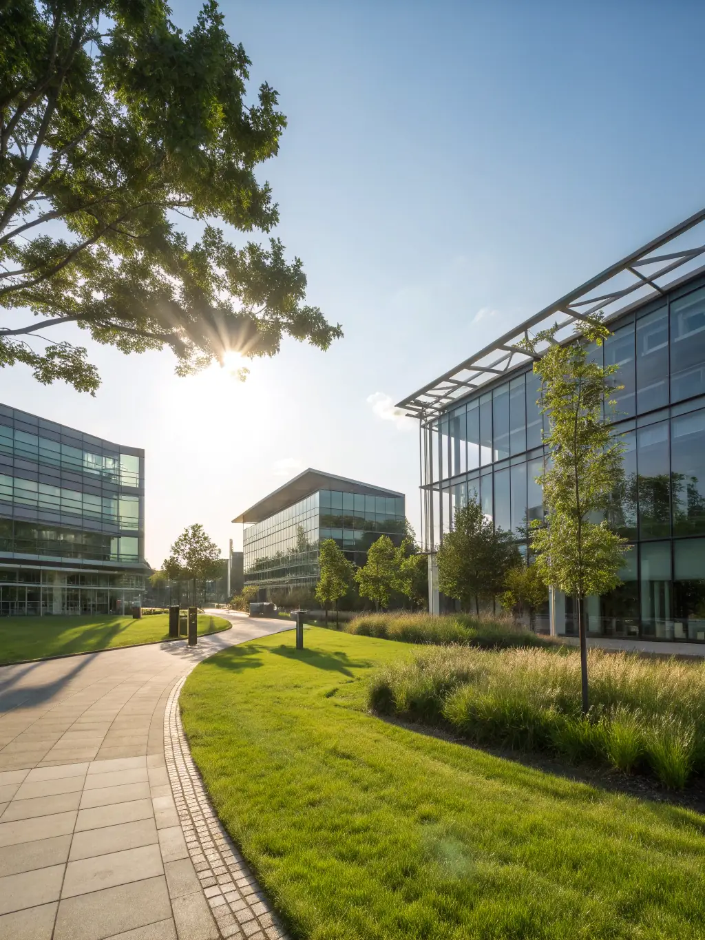 A high-angle, brightly lit photograph of the Cambridge Science Park, showcasing modern architecture and green spaces, symbolizing innovation and technology.
