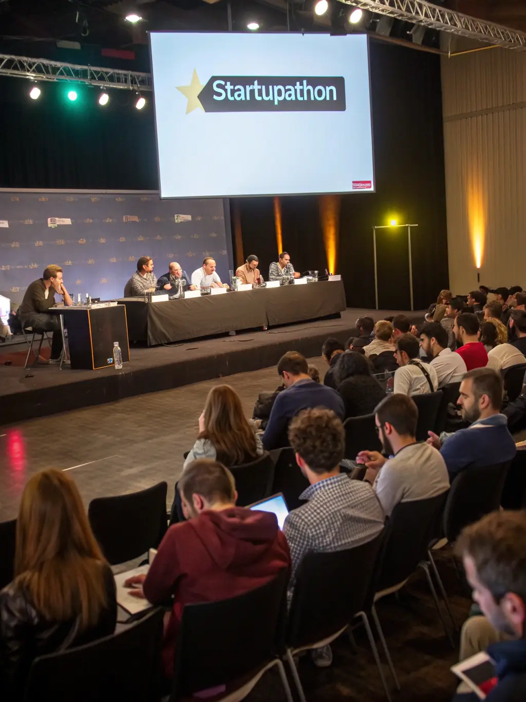 A photograph of a startup pitching their innovative product to a panel of judges at the Innovation Summit UK 2023, highlighting the entrepreneurial spirit of the event.